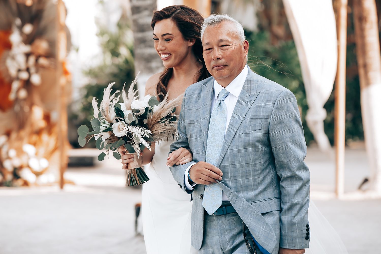 A couple shares joyful moments in formal attire during an outdoor wedding photoshoot.