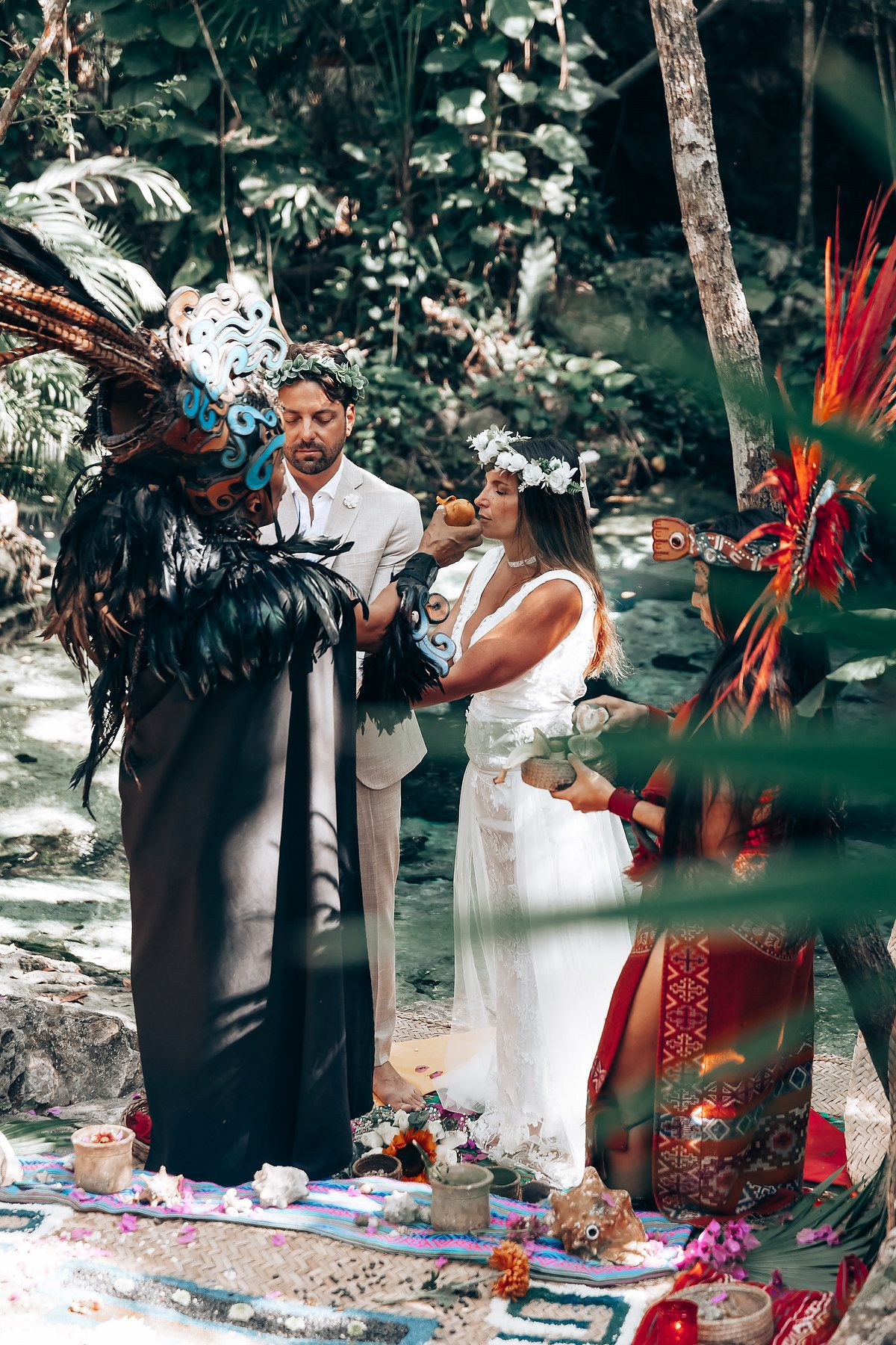 A spiritual ceremony taking place in a forest clearing with colorful traditional decorations and ceremonial items.