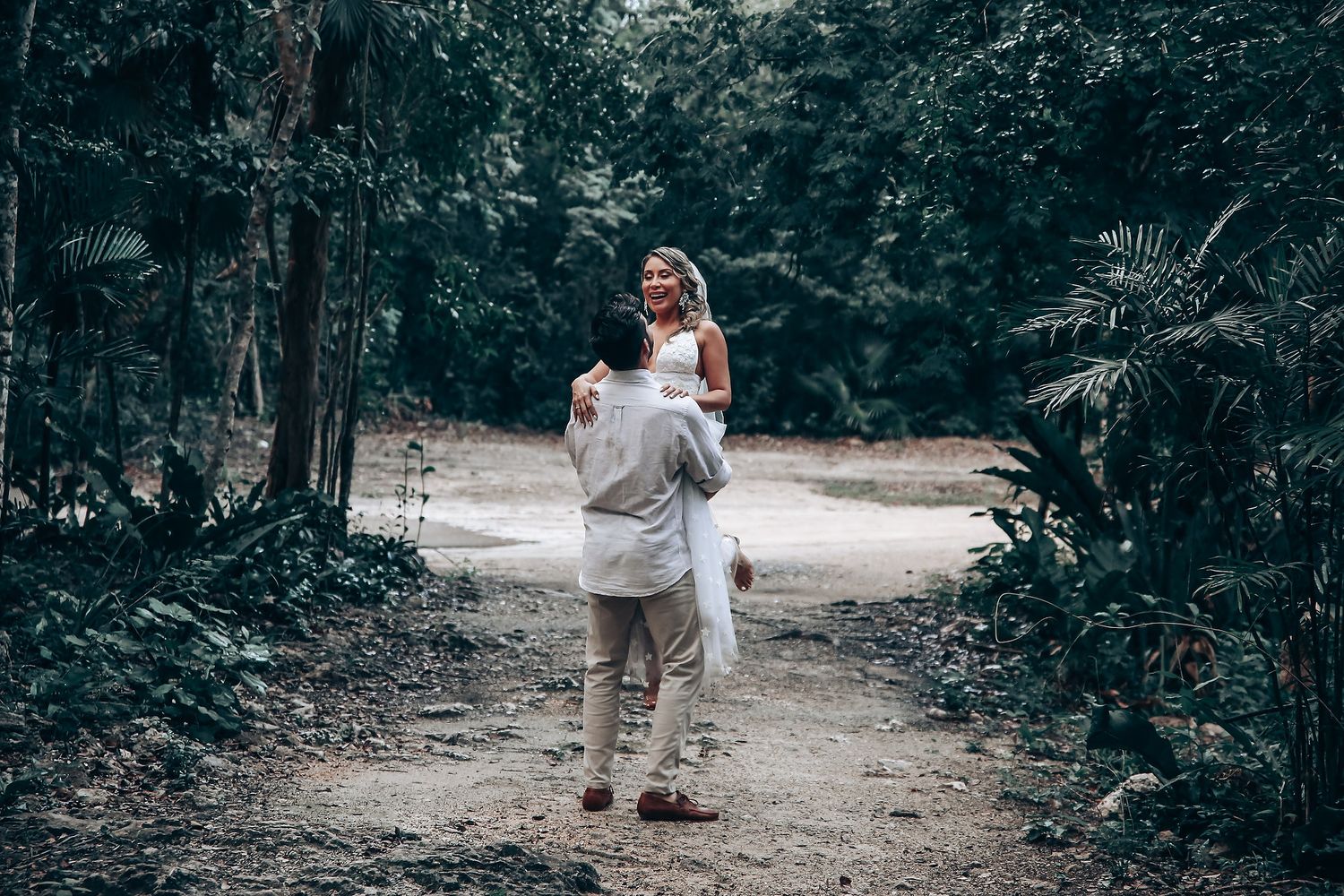 A couple shares tender moments during their woodland wedding photoshoot.