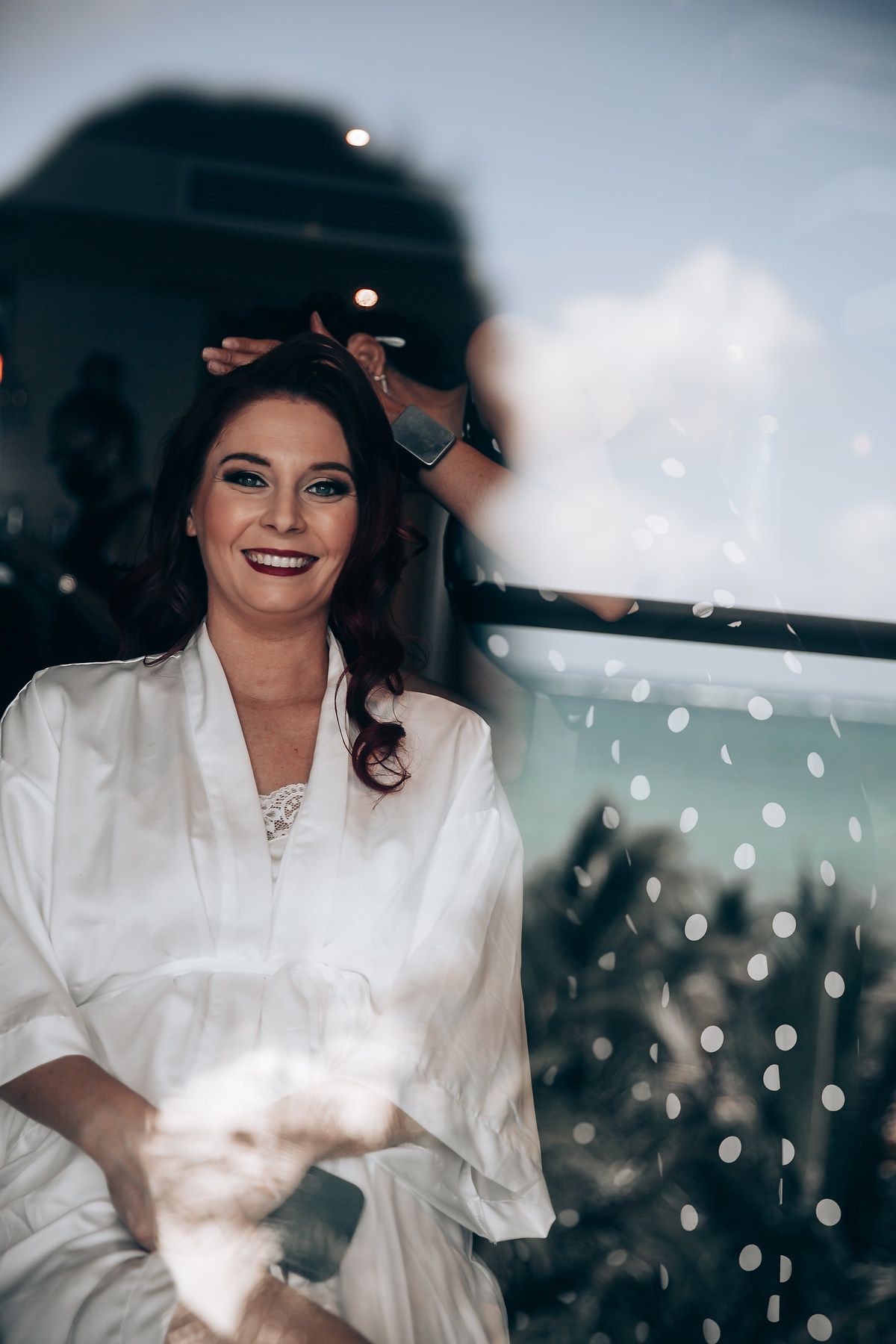 A series of photos showing someone in a white robe smiling and getting ready with sparkling lights in the background.
