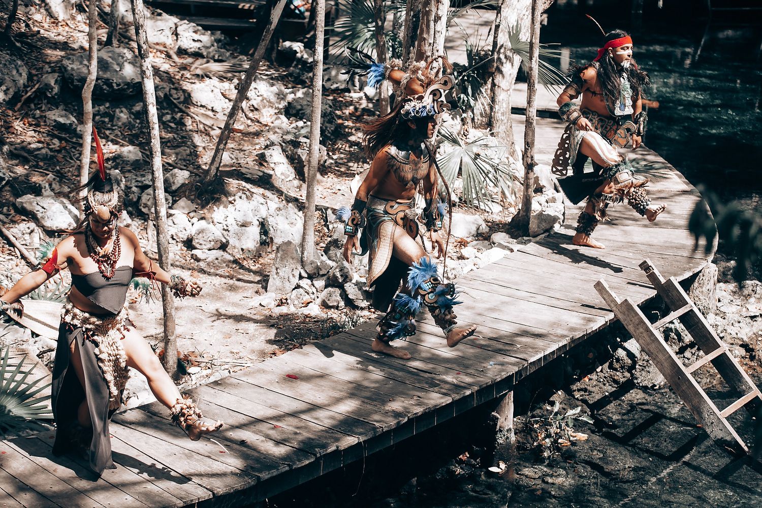 A group gathers outdoors for a spiritual ceremony among trees and natural surroundings.
