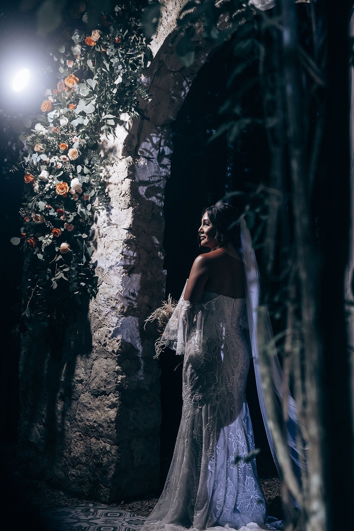 Moody and artistic wedding portrait among birch trees with dramatic lighting.