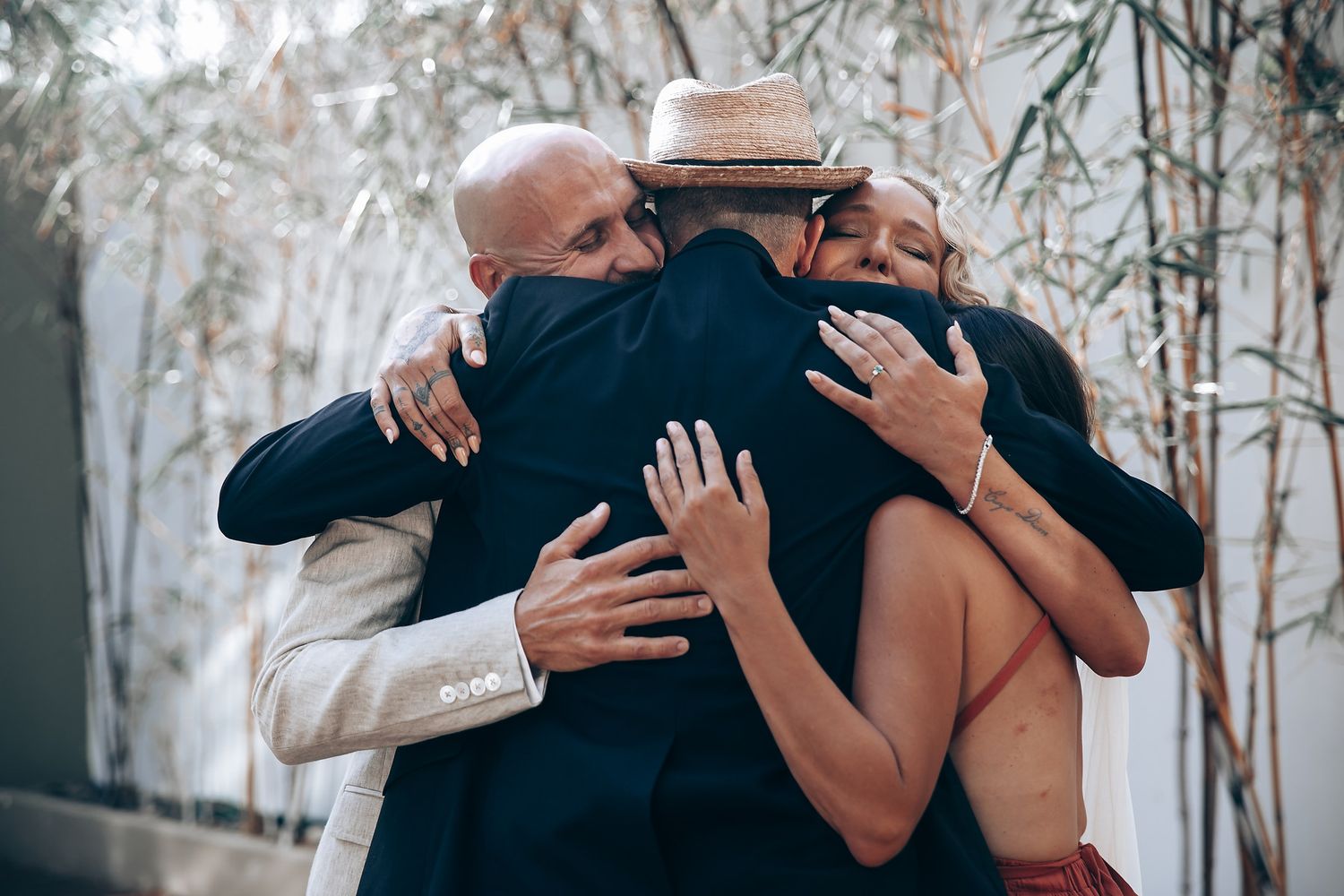 Emotional wedding moments captured in a series of intimate embraces between couples during a ceremony.