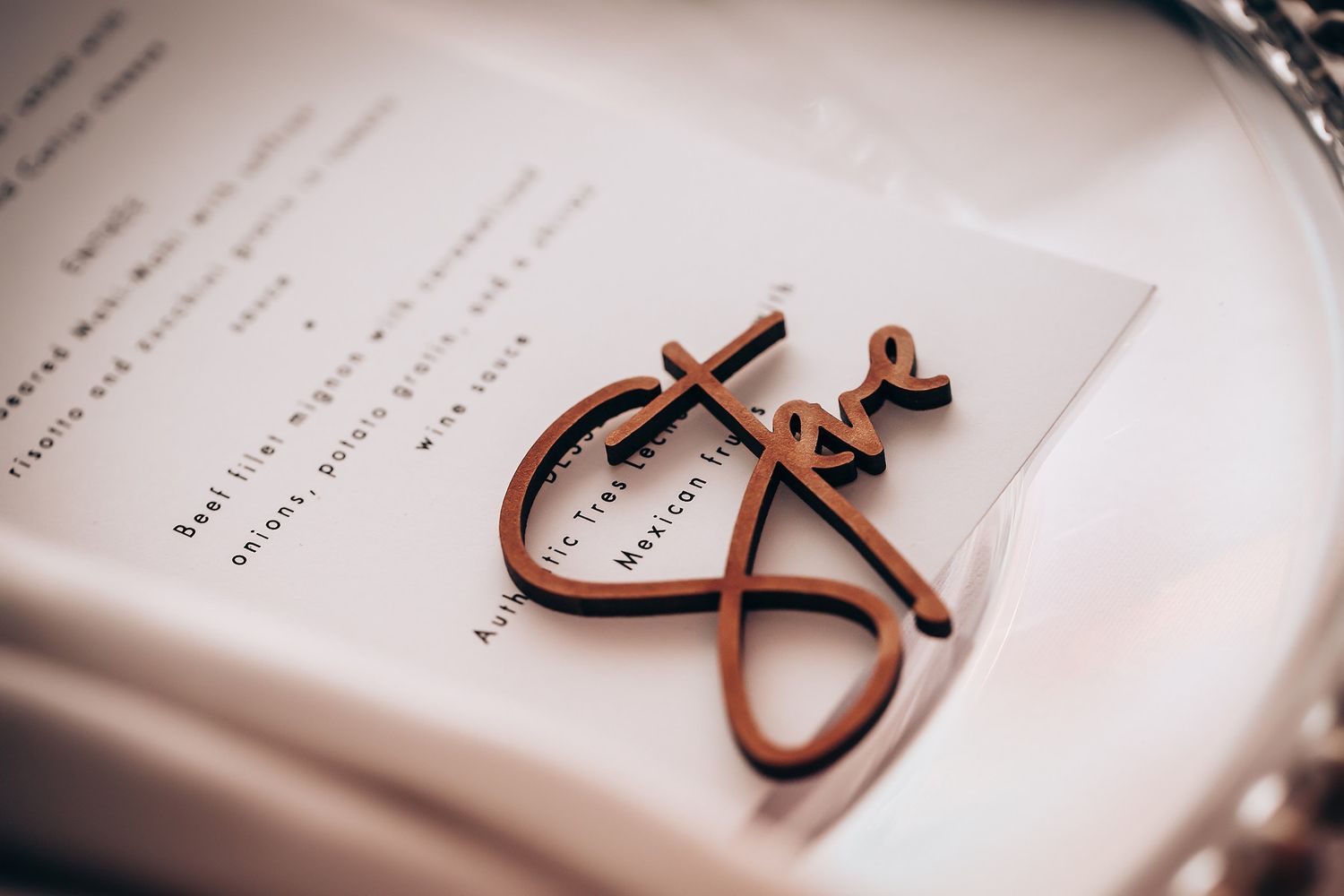 Wedding rings and decorative elements photographed on printed paper.