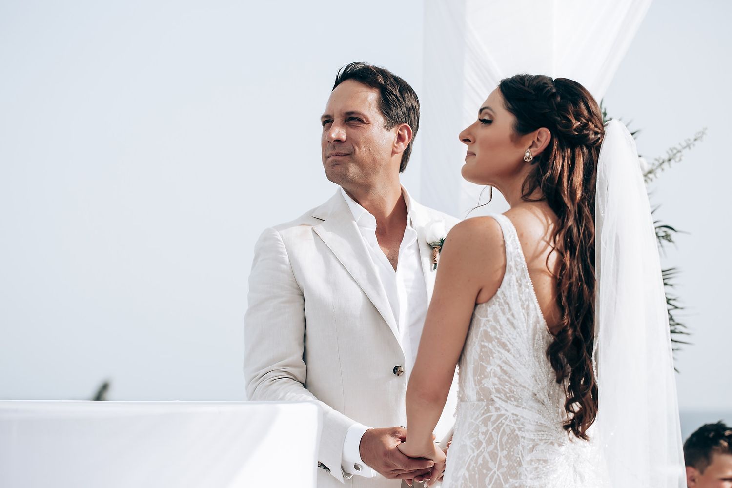 Romantic wedding moments captured in an elegant white interior setting.