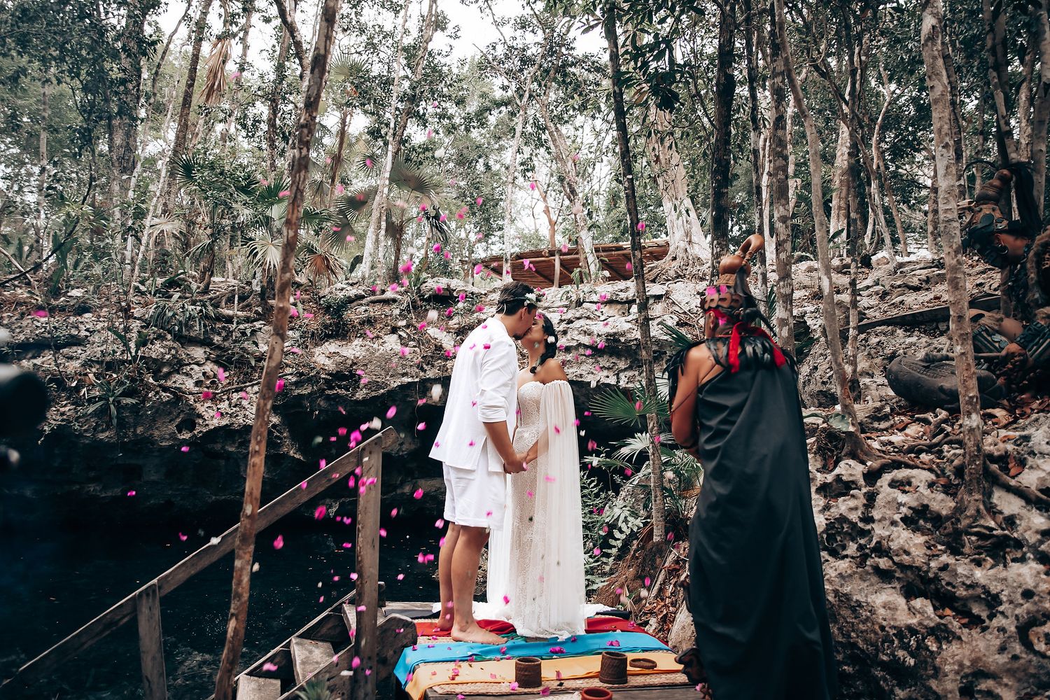 A couple walks through a wooded forest path during an outdoor photoshoot session.
