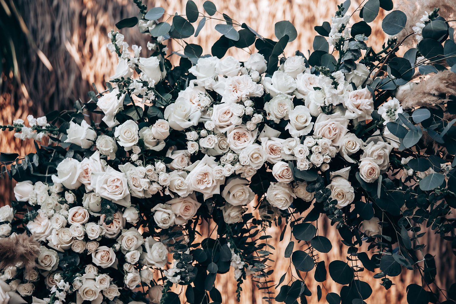 Elegant white rose floral arrangement creating a romantic wedding backdrop.