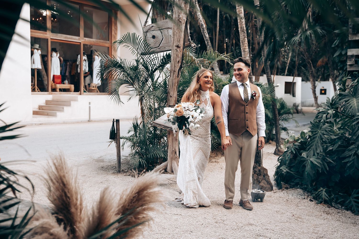 Wedding celebration in a tropical garden setting with palm trees and natural decor.