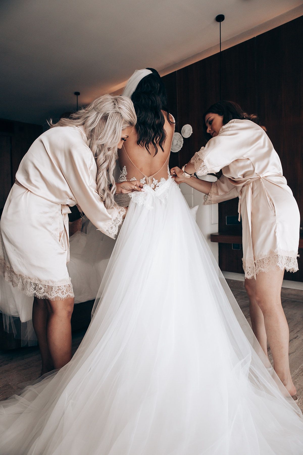 Close-up shots of a wedding dress being fitted and adjusted before the ceremony.