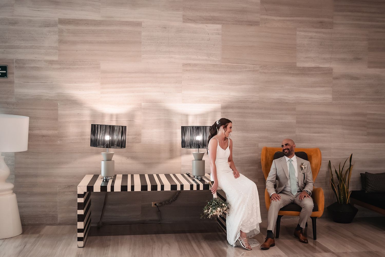 Modern wedding venue interior with woven chairs and wood-paneled walls creating a contemporary ambiance.