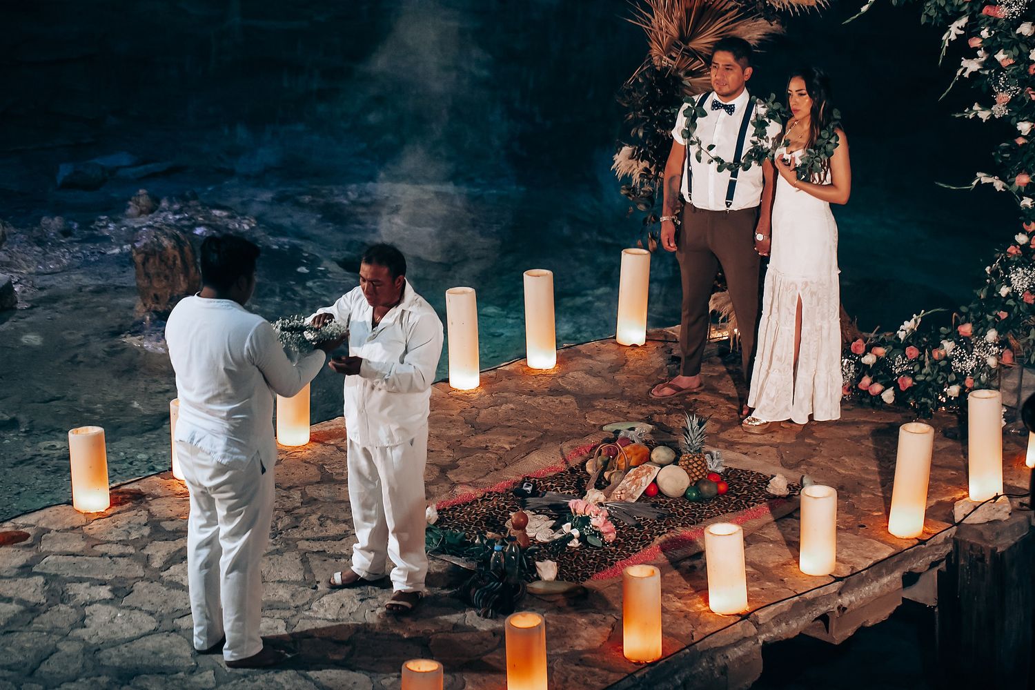 Paper lanterns line a path at dusk creating a romantic outdoor lighting display for an evening event.