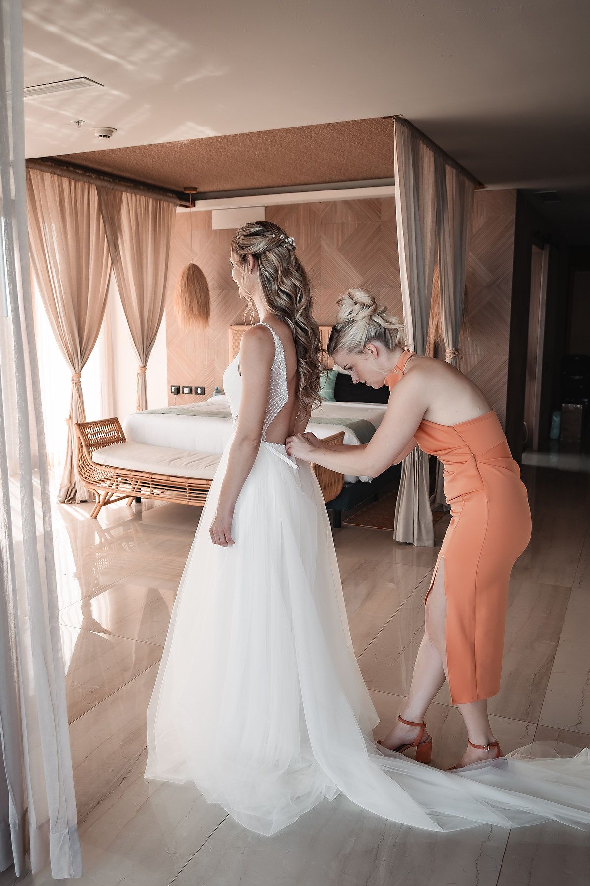 Wedding dress preparations showing the bustling and adjusting of a flowing white gown.