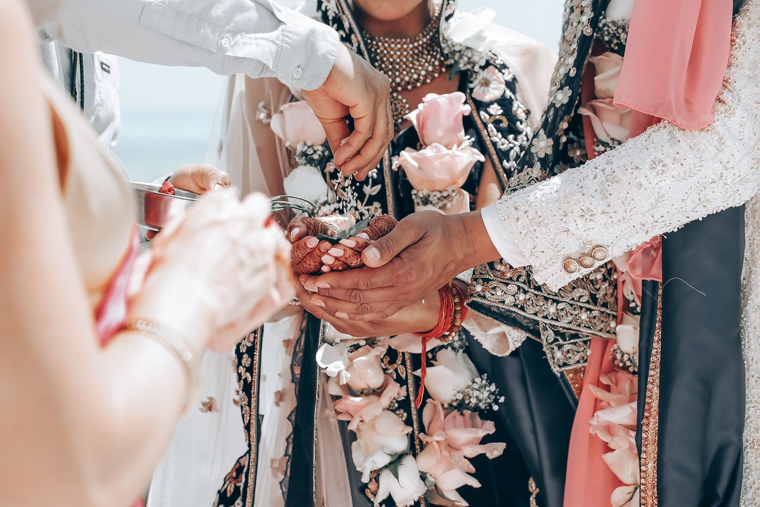 Wedding celebration table decorated with pink and white floral arrangements at an outdoor venue.