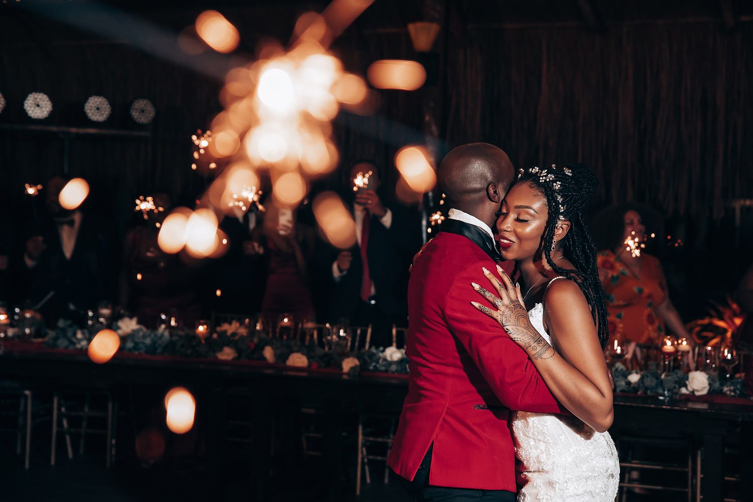 Couple dancing romantically at night with glowing bokeh lights creating a magical atmosphere.