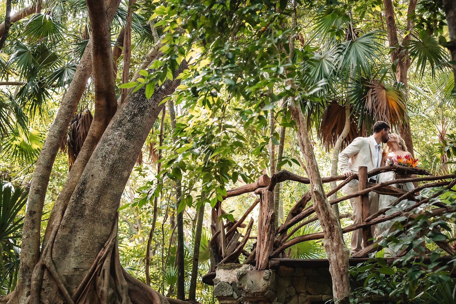 Scenic tropical garden wedding venue with tall trees and natural lighting.