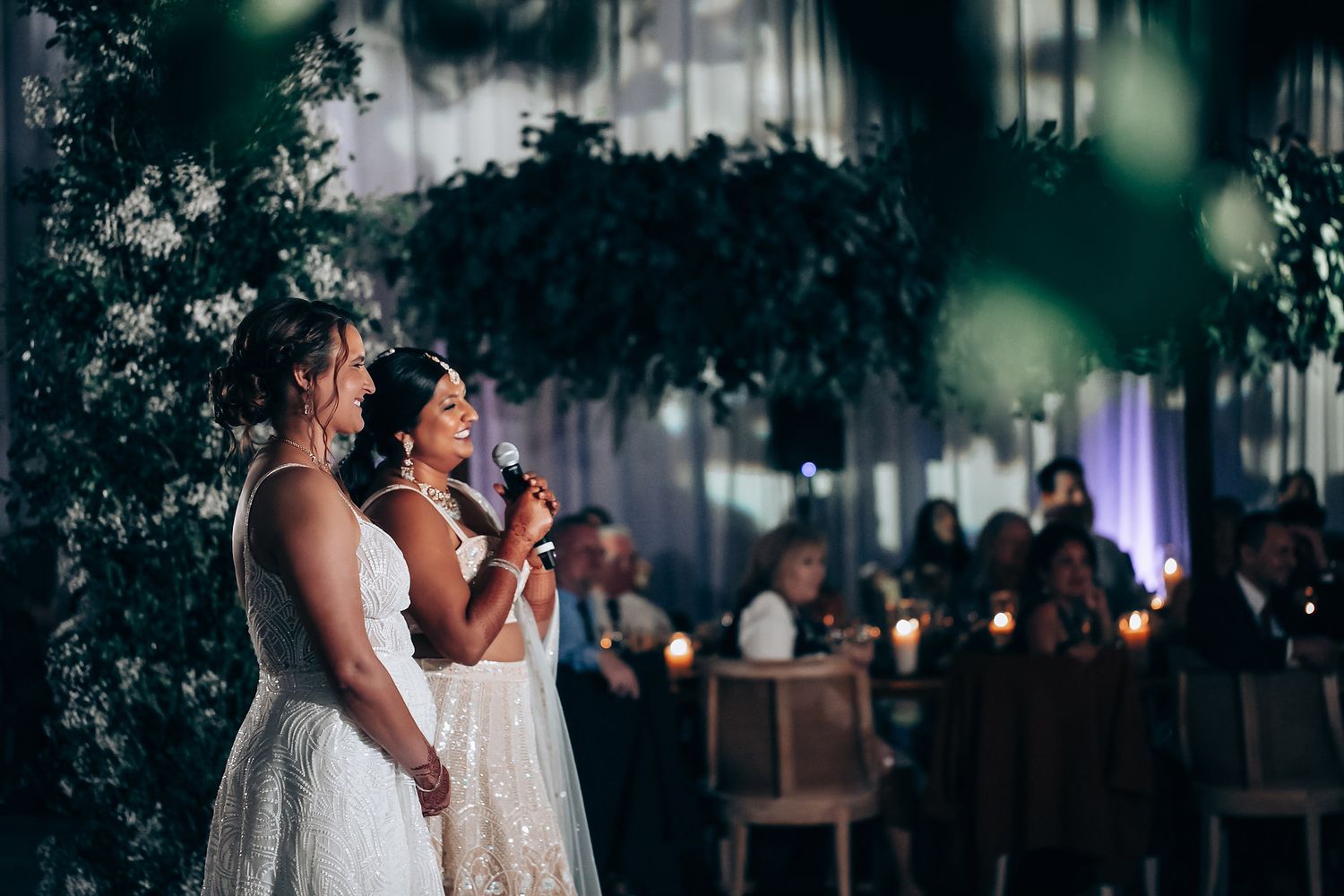Wedding party dancing and celebrating in an elegantly decorated reception space.