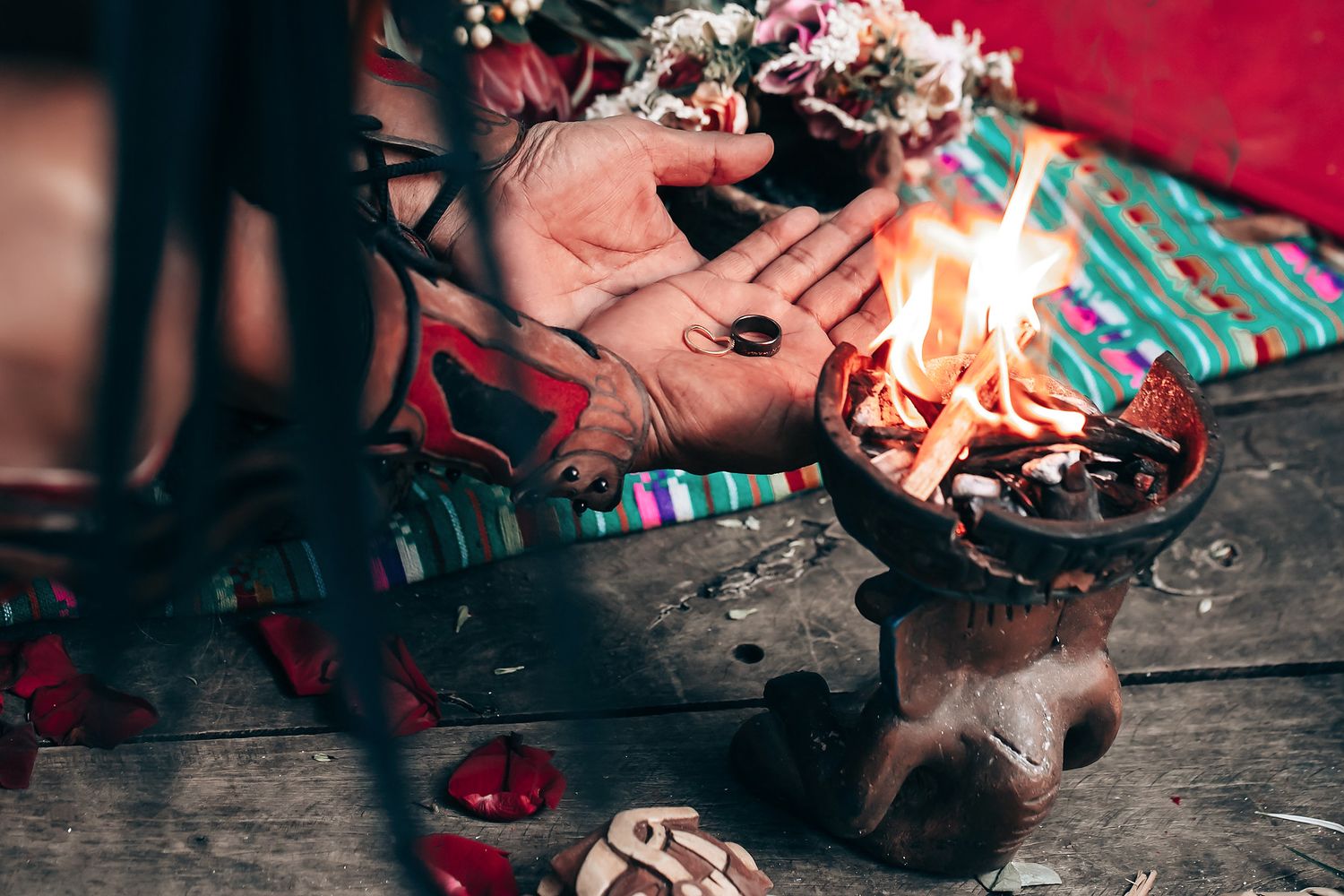 Ceremonial burning of copal incense during traditional Mayan ritual on wooden surface.