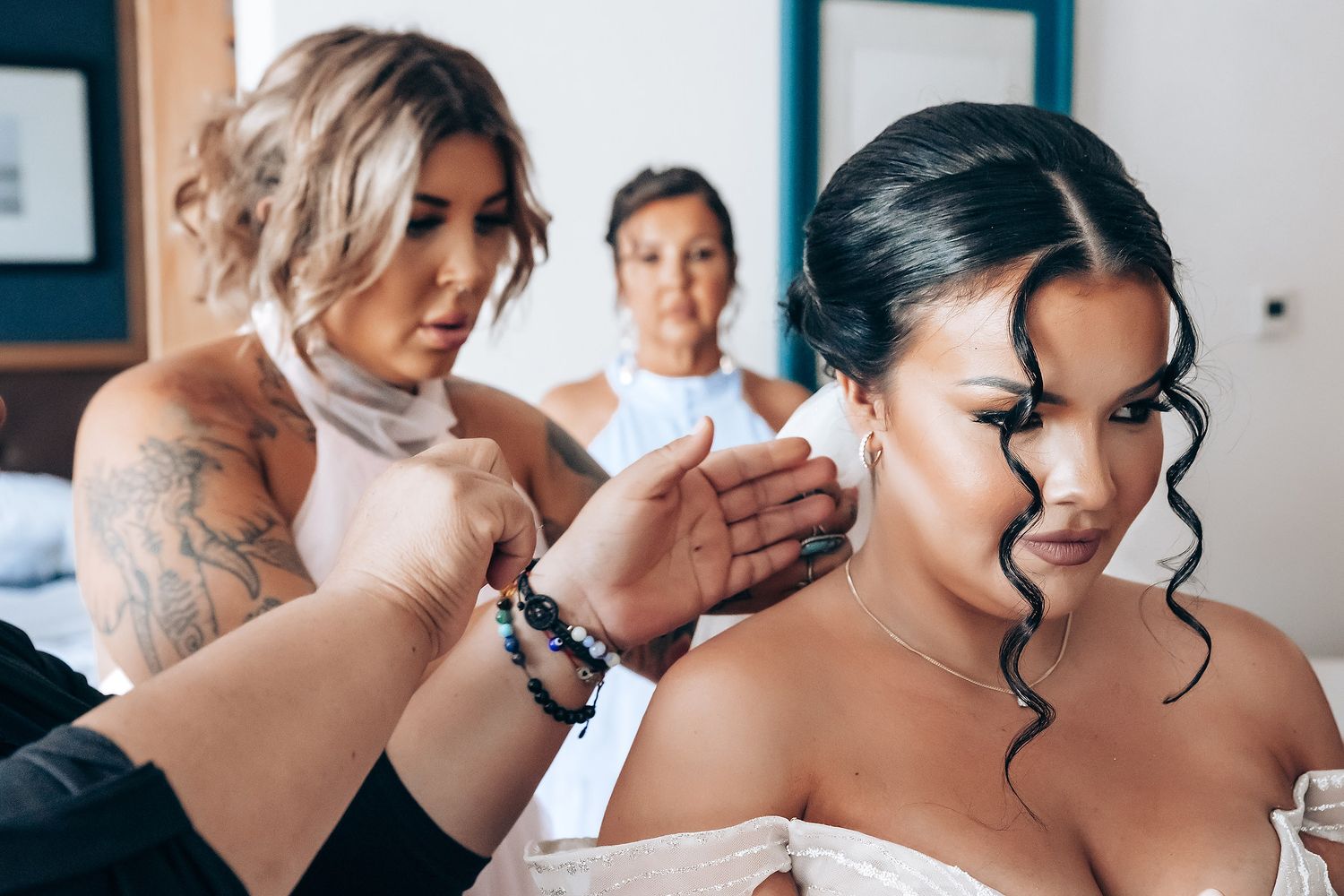 Multiple shots of makeup artist working on bride's final beauty preparations before the ceremony.