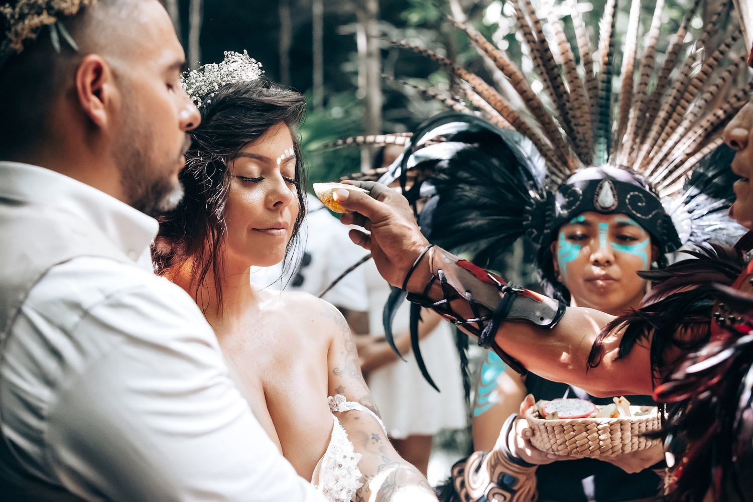 Wedding ceremony incorporating indigenous or traditional cultural elements outdoors.