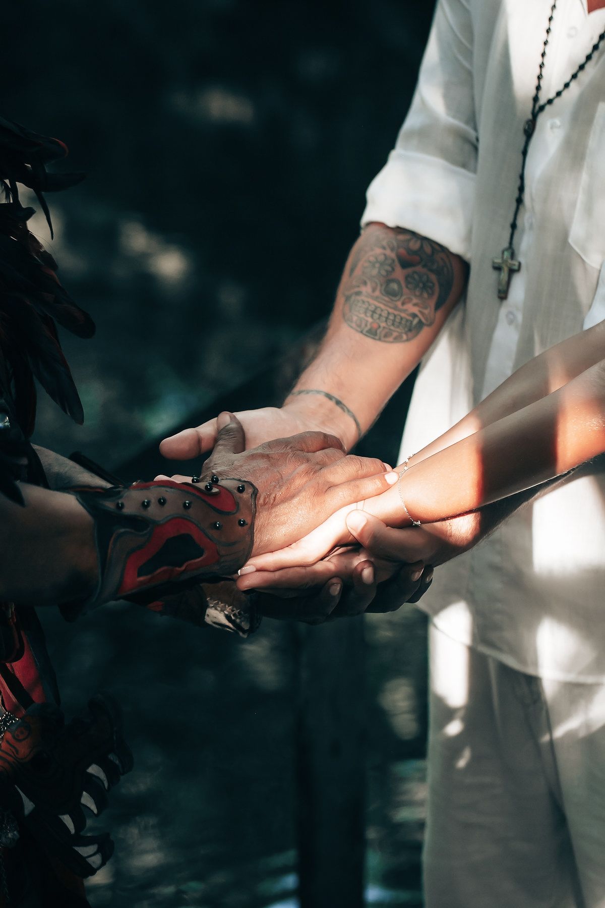A close-up view of a tattooed arm of an individual, possibly during a wedding or ceremony.