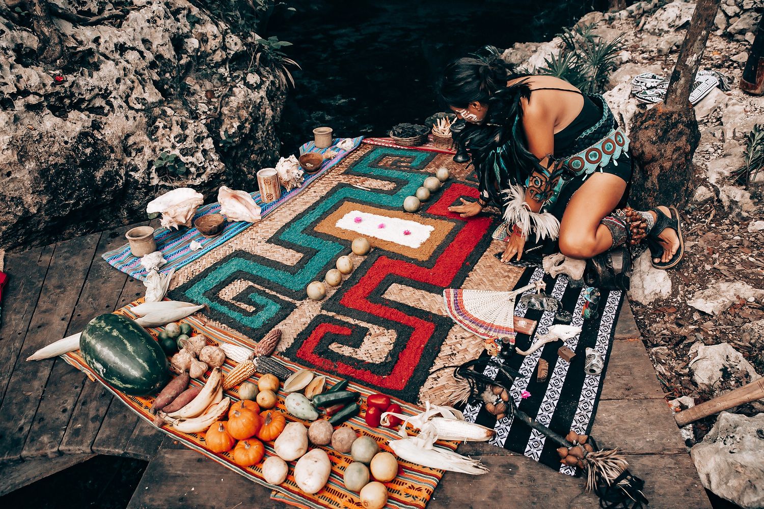 Traditional Hawaiian luau feast laid out on woven mats with tropical fruits and fresh ingredients.
