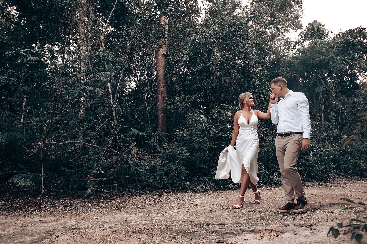 Natural outdoor photography session along wooded path during golden hour.