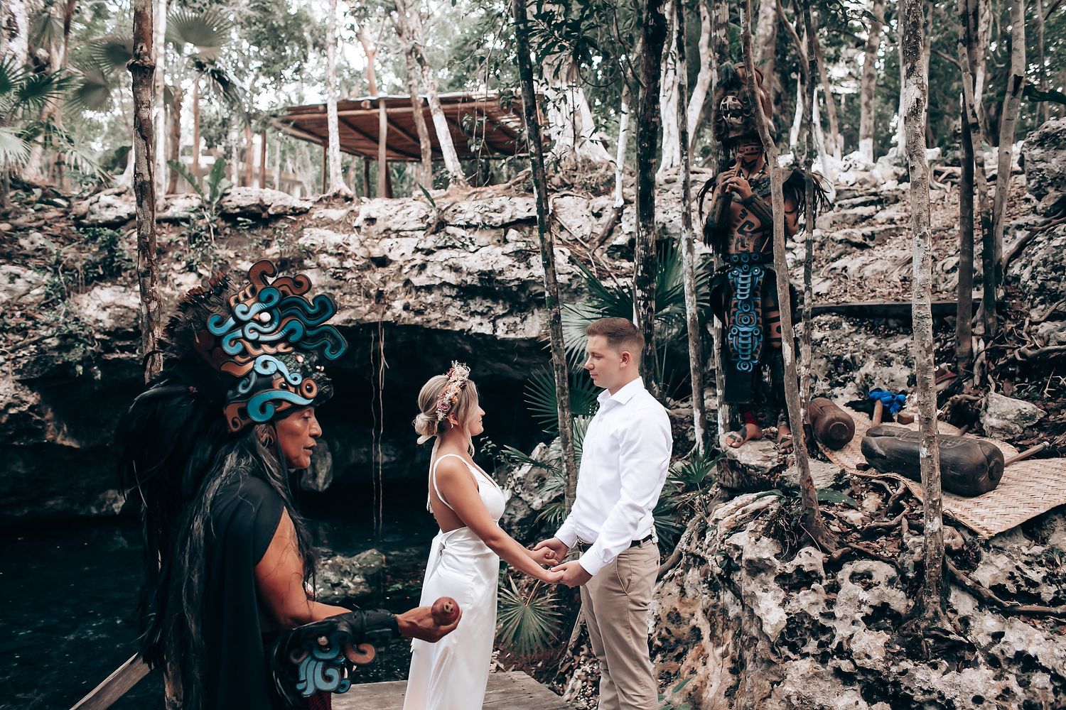 A romantic outdoor photo session in a wooded area with natural lighting and rocky terrain.