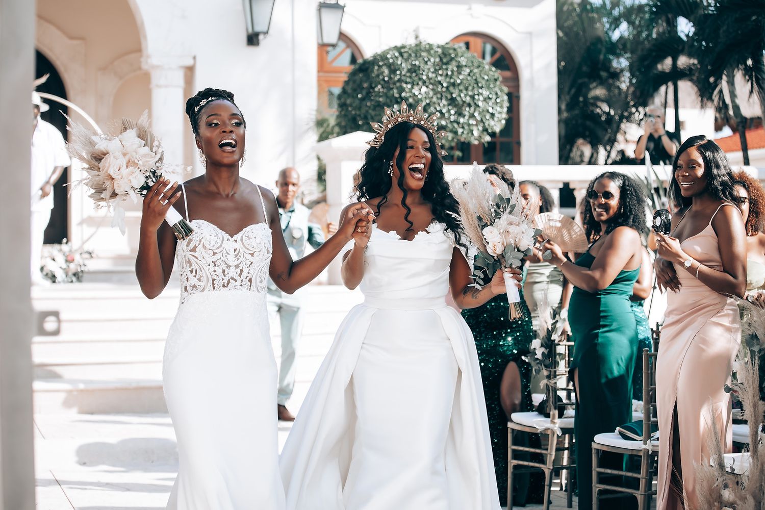 Wedding party celebrating under covered outdoor venue with festive atmosphere.