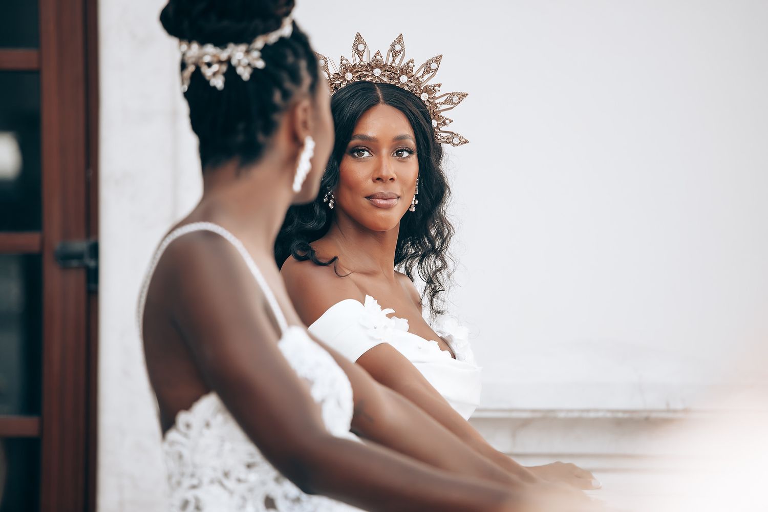 Romantic bridal portraits showing a white wedding dress against a light background.