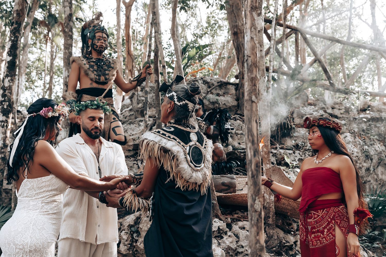 Traditional ceremony with smoke and rituals performed in forest setting.
