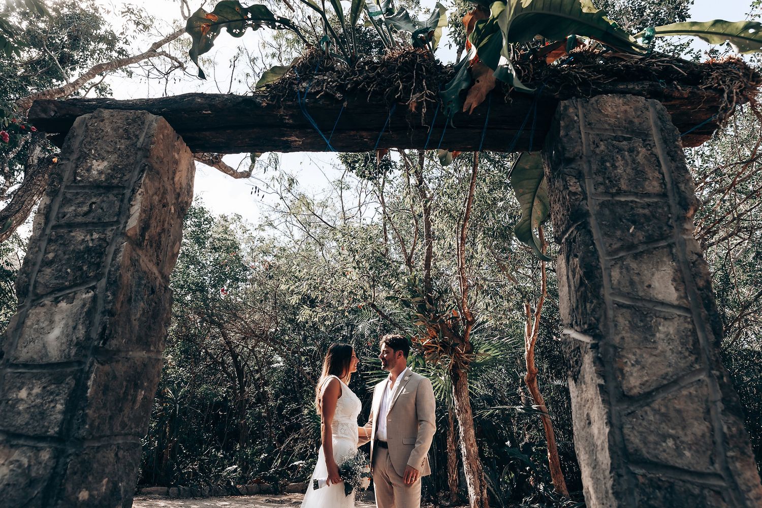 A forest wedding setup with traditional ceremonial elements and natural lighting filtering through trees.