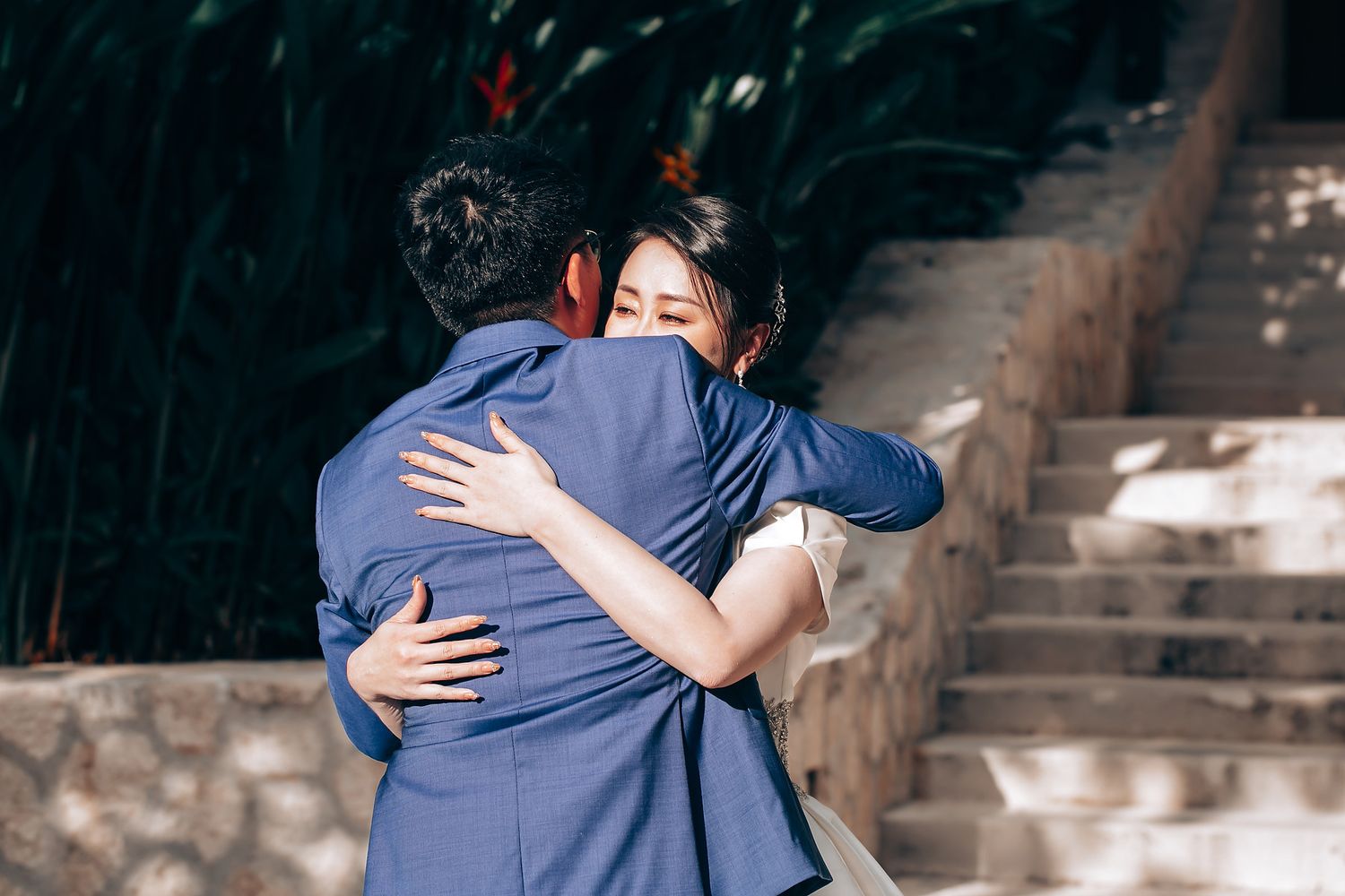 Emotional embraces shared during wedding celebrations in formal attire.