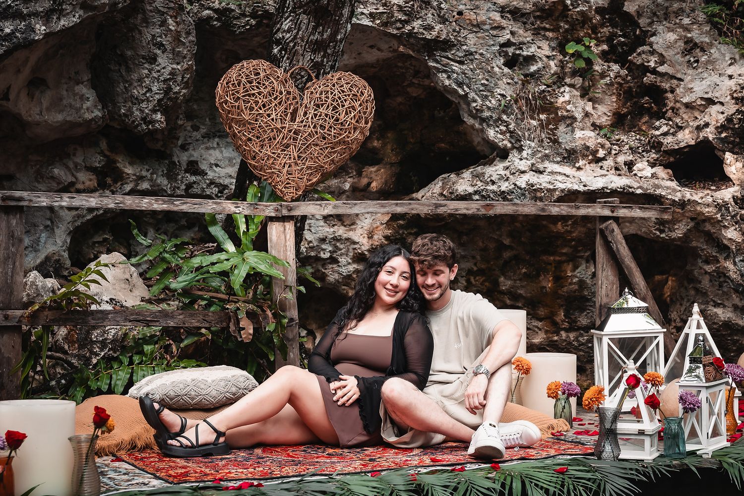 Romantic setup with heart decorations and cushions by a tranquil cenote pool in Mexico.