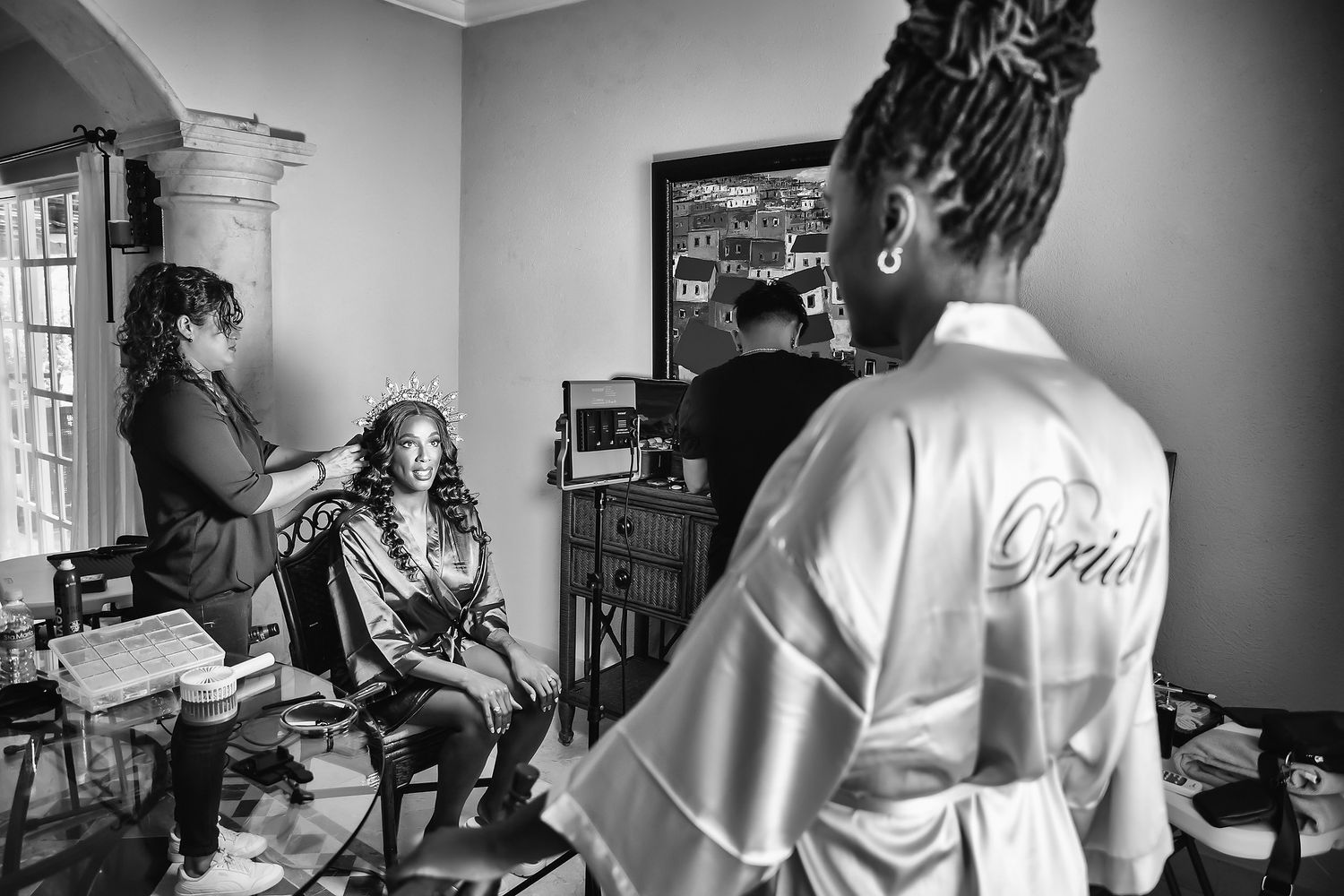 Black and white behind-the-scenes shots of wedding day preparation.