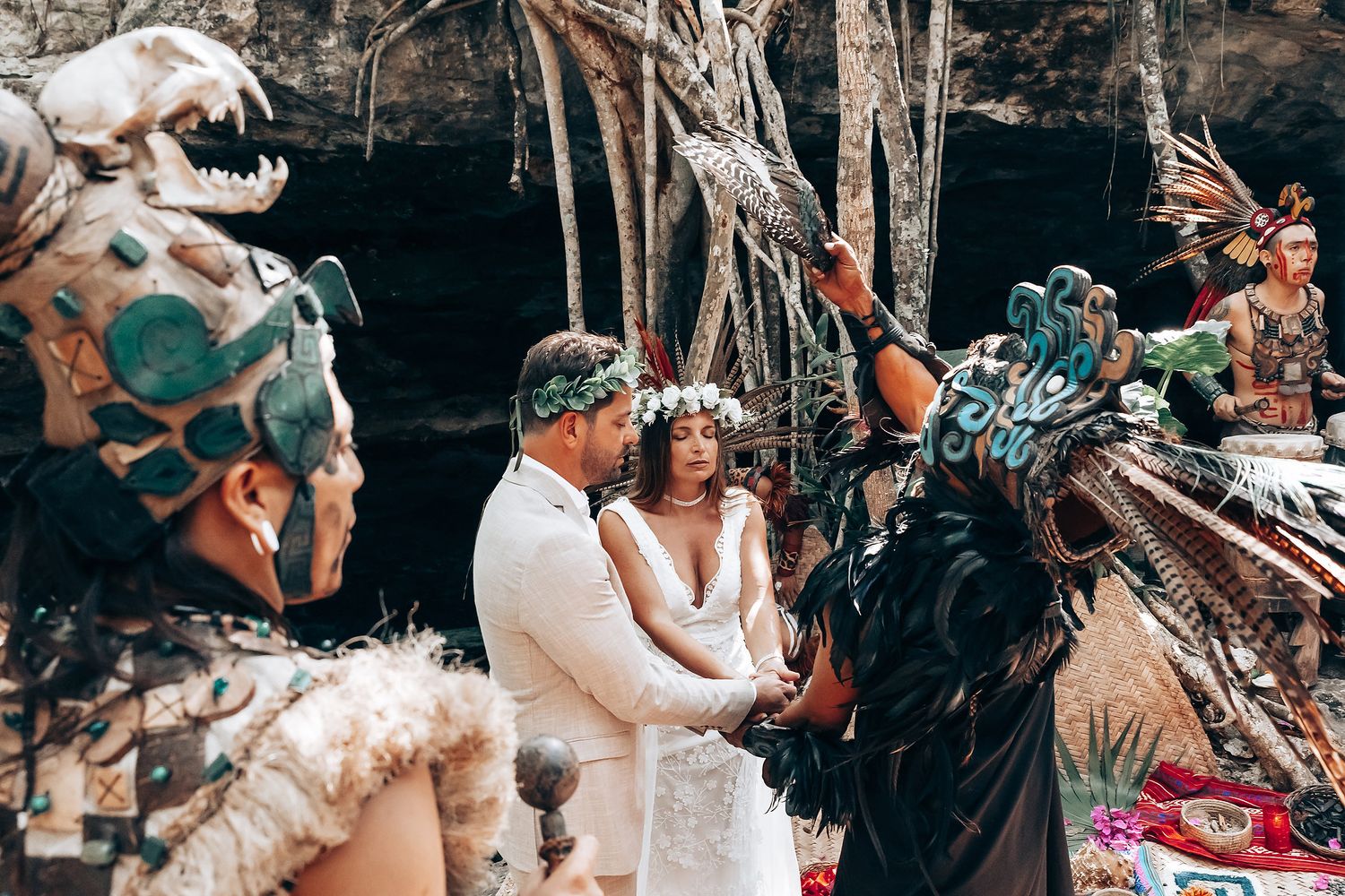 Traditional Mayan ceremony performers in elaborate feathered headdresses participate in a wedding ritual.