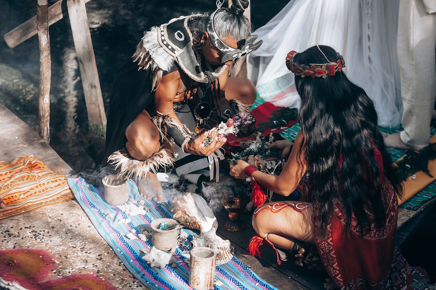A series of photos showing someone receiving traditional tattoo art with traditional tools and methods.
