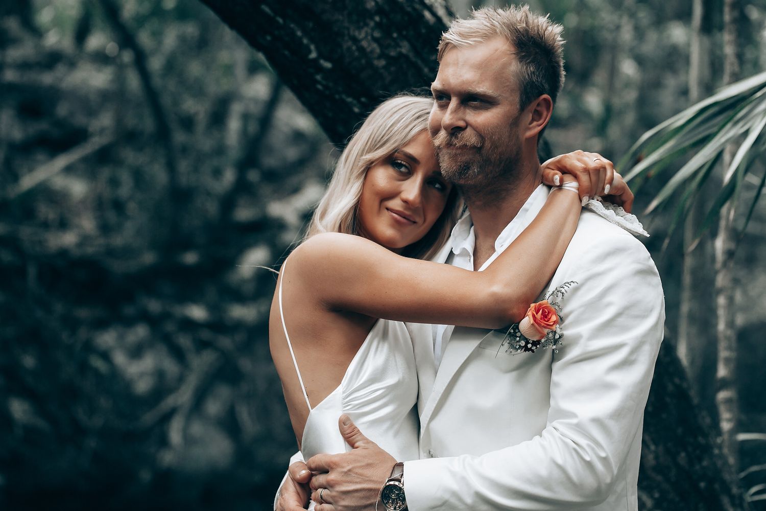 A couple shares an intimate dance moment during their forest wedding celebration.