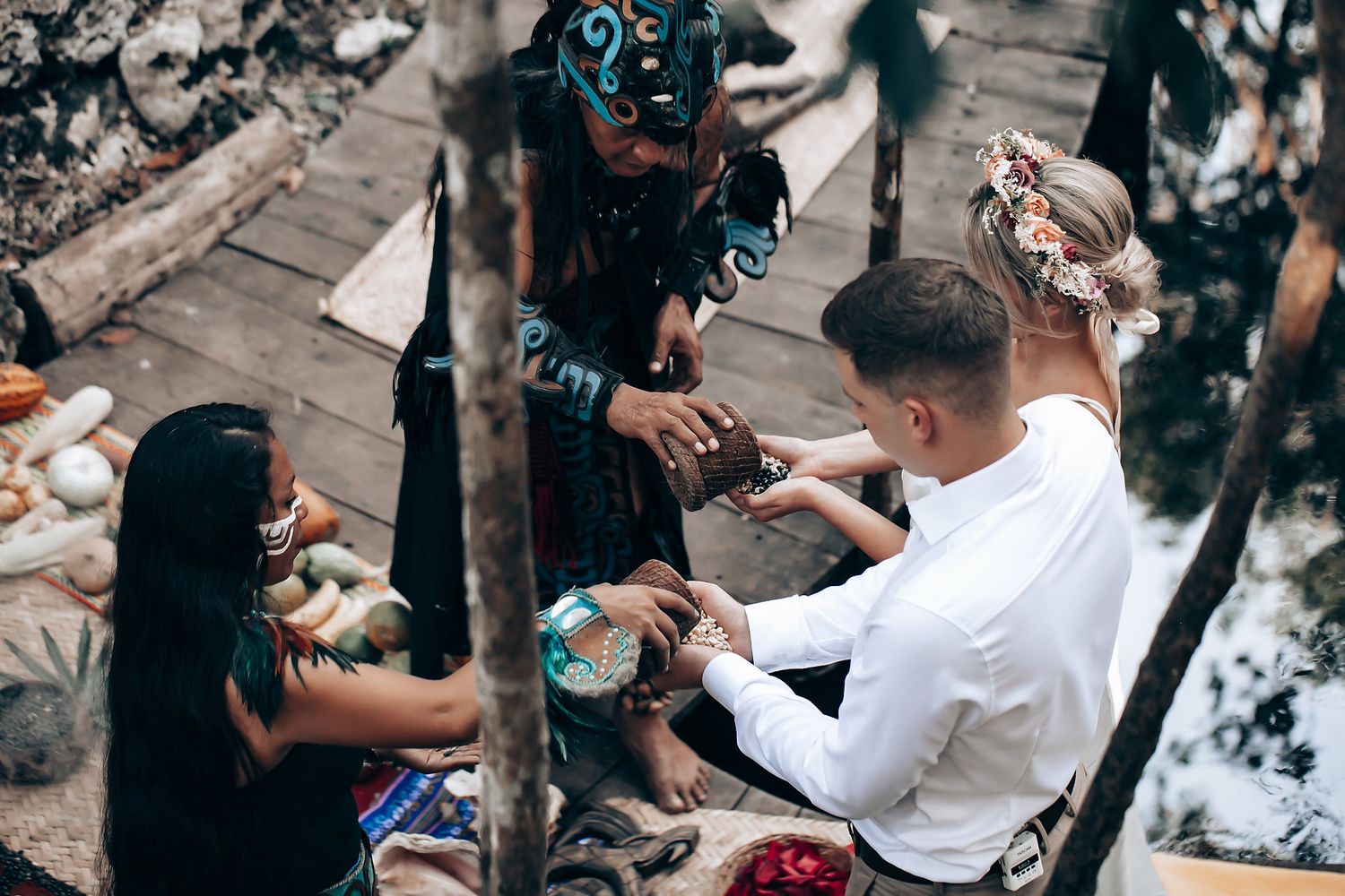 Wedding guests gather around in an outdoor celebration with decorative blue lighting.