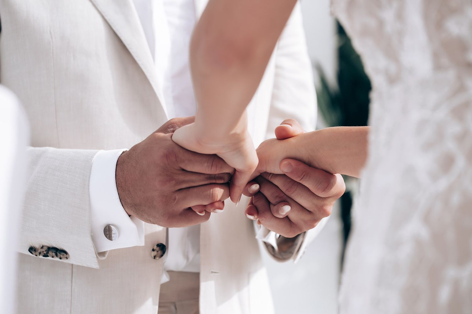 Wedding party members adjusting formal attire before the ceremony.