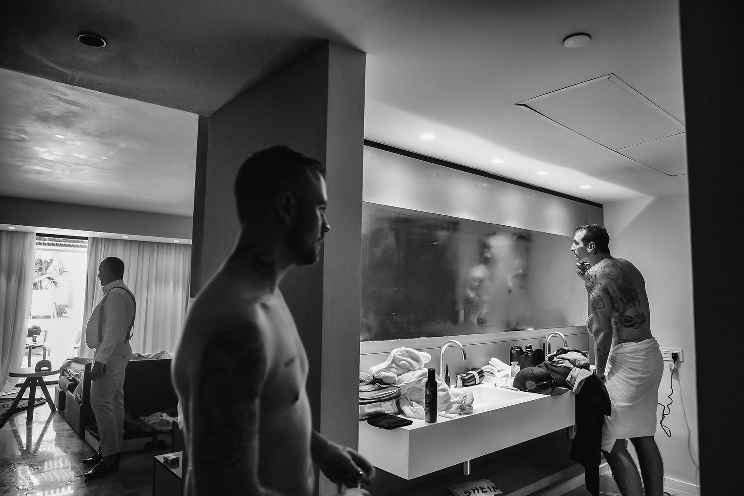 A sequence of black and white surveillance camera stills showing movement through an interior hallway space.