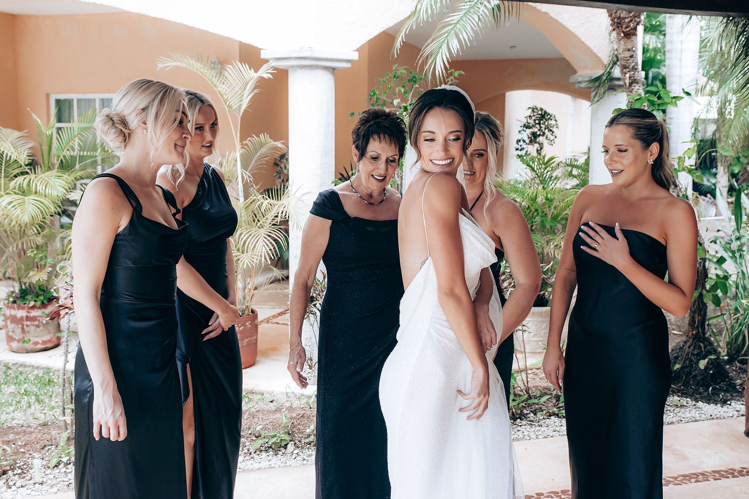 Wedding party preparations in coordinated black and white attire.