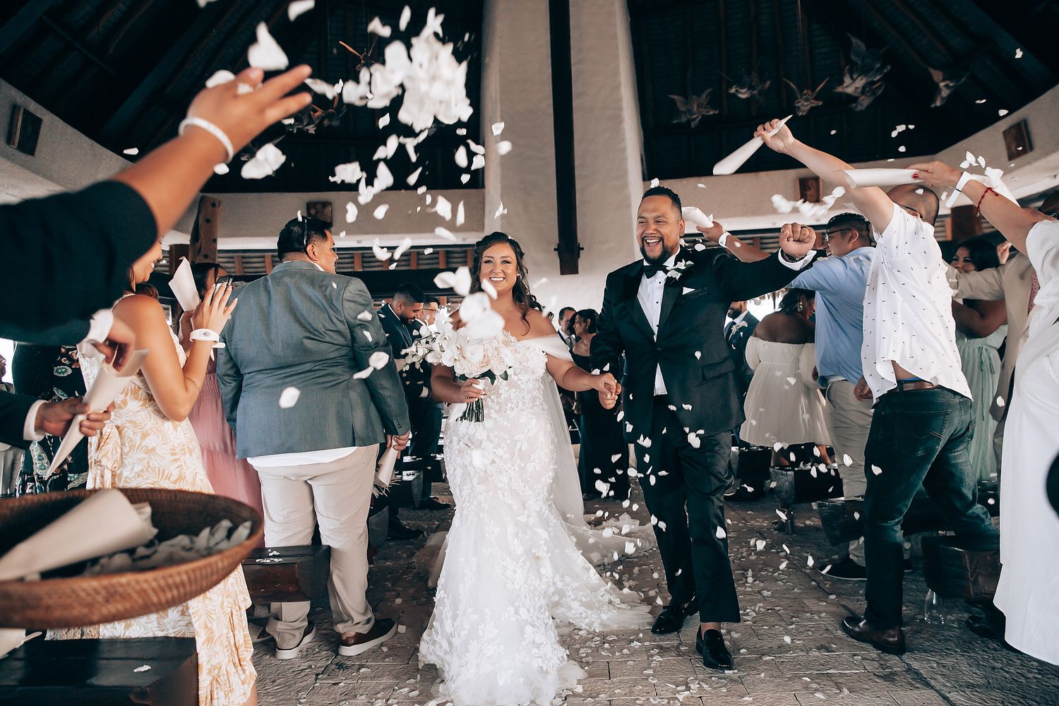 Confetti fills the air during a joyous wedding celebration as guests dance and celebrate.