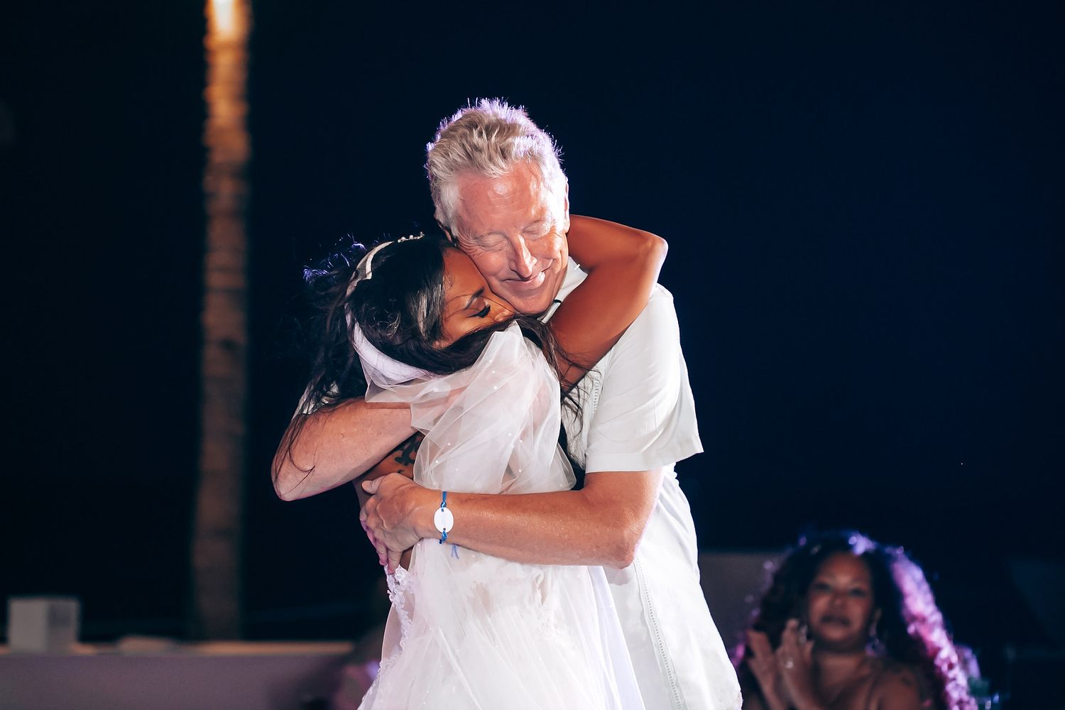 Wedding reception dance moment captured under evening lights.