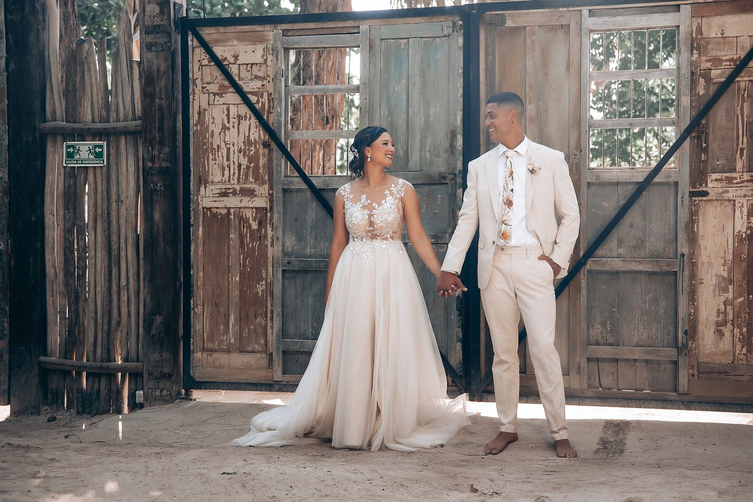 Vintage barn wedding venue with rustic wooden doors and natural lighting.