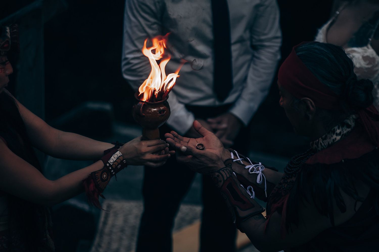 Sparklers create magical light trails in the darkness at an outdoor celebration.