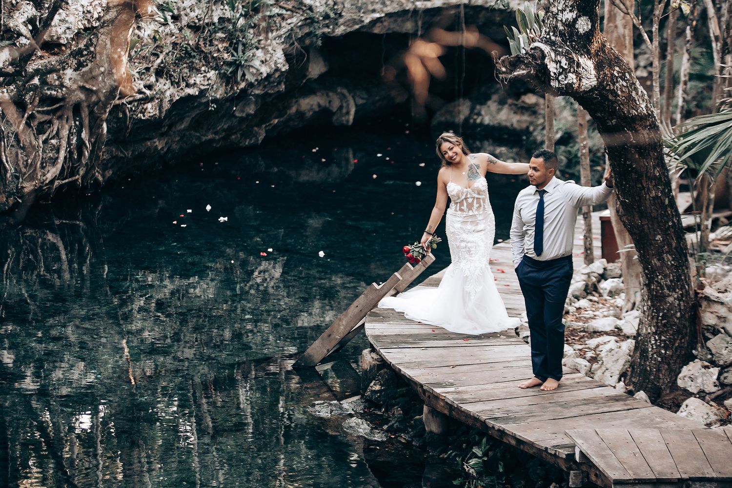 A wooden boardwalk winds through a natural outdoor wedding venue setting.