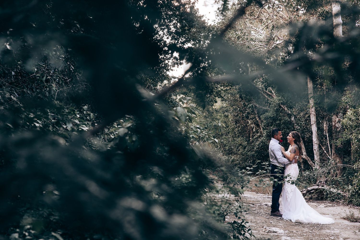 Artistic wedding photography sequence captured in a moody forest setting.