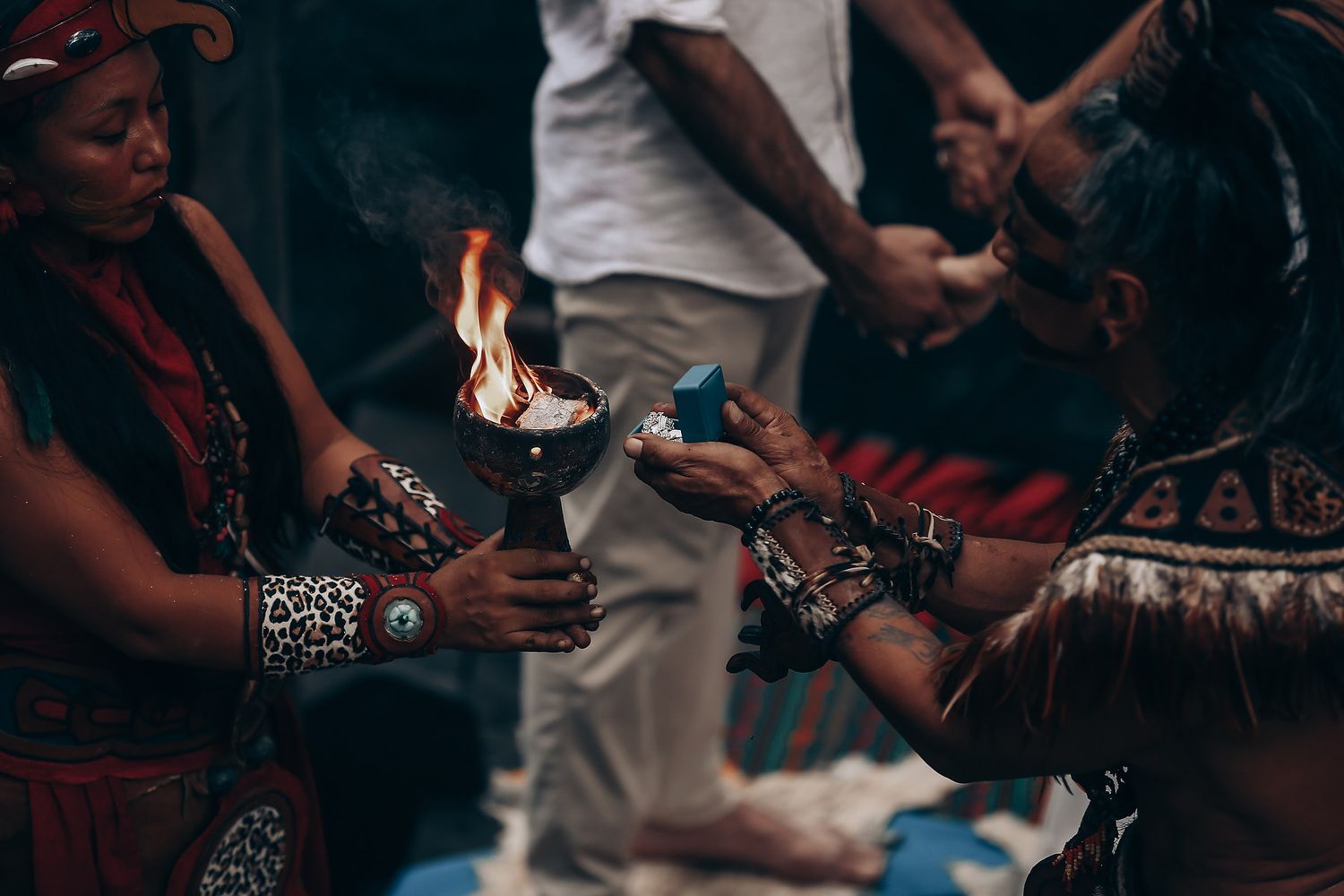 Traditional fire ceremony being performed with ceremonial tools and decorative elements.