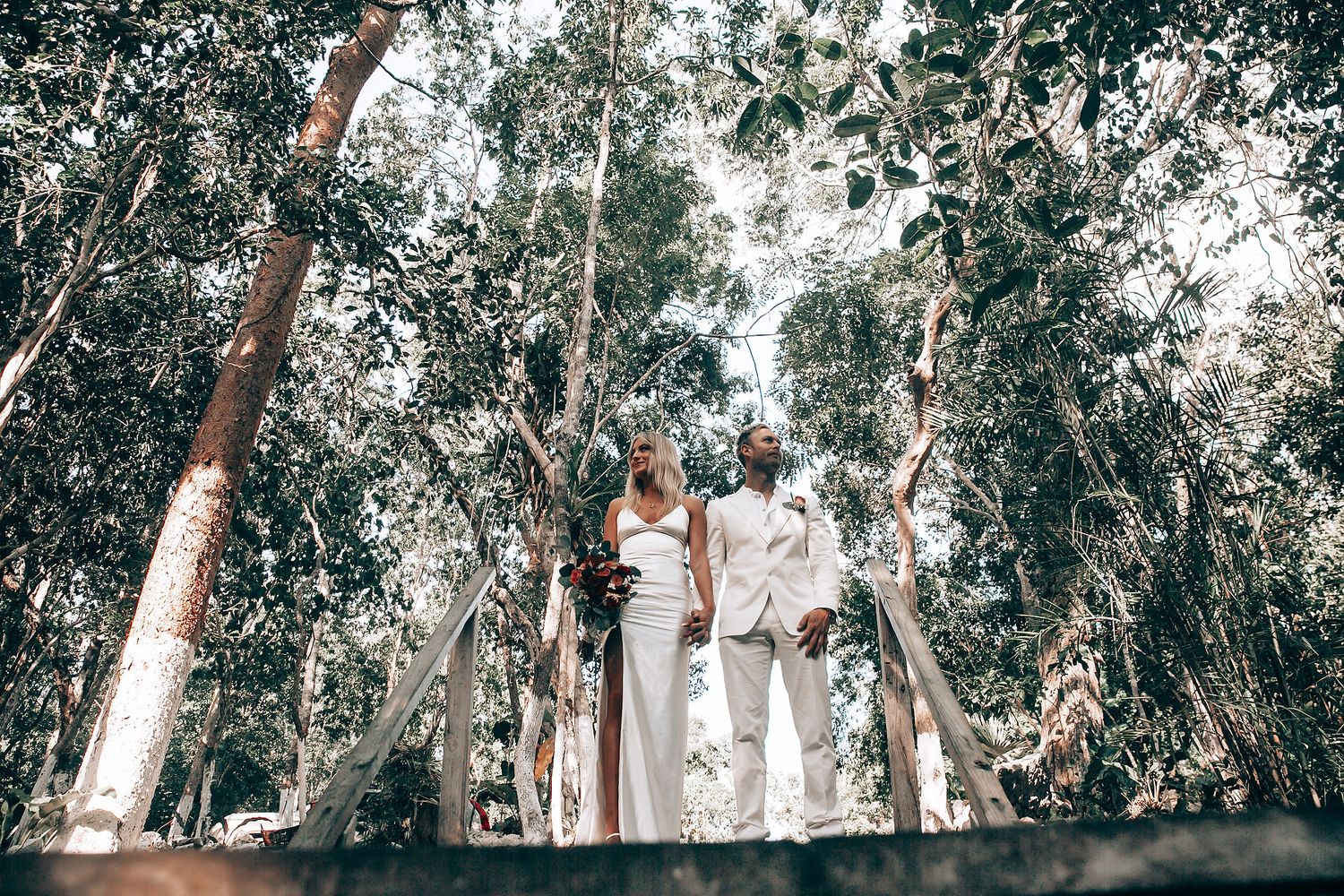 Panoramic view of wedding ceremony setup in a wooded forest area.