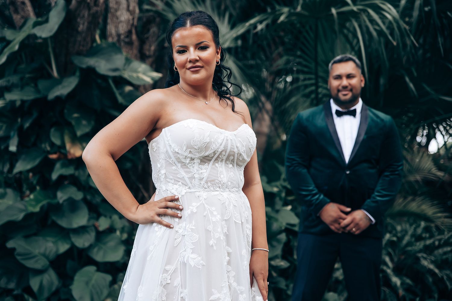 Elegant wedding portraits captured in a lush tropical garden setting.